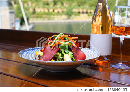 Seasonal Salad with Homemade Pastrami or bacon. With blush or rose wine. 128840465