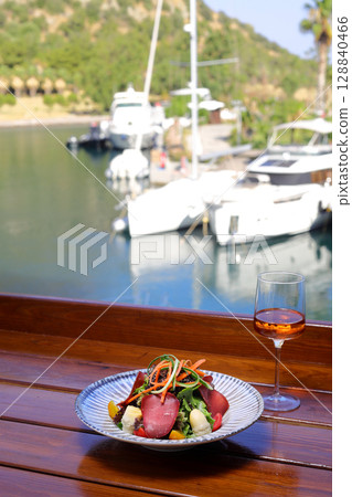 Seasonal Salad with Homemade Pastrami or bacon. With blush or rose wine. 128840466