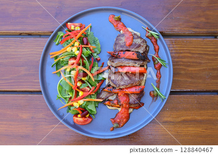 beef chop steak with salad , fried potatoes and sauce in dish. Food and Vegetable concept beef chop steak with salad , fried potatoes and sauce in dish. Food and Vegetable concept 128840467