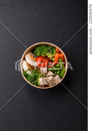 Vegan salad, bowls with chickpeas, broccoli, tomatoes, tofu cheese and boiled eggs Vegan salad, bowls with chickpeas, broccoli, tomatoes, tofu cheese and boiled eggs 128840476