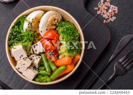 Vegan salad, bowls with chickpeas, broccoli, tomatoes, tofu cheese and boiled eggs Vegan salad, bowls with chickpeas, broccoli, tomatoes, tofu cheese and boiled eggs 128840483