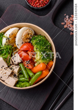 Vegan salad, bowls with chickpeas, broccoli, tomatoes, tofu cheese and boiled eggs 128840484