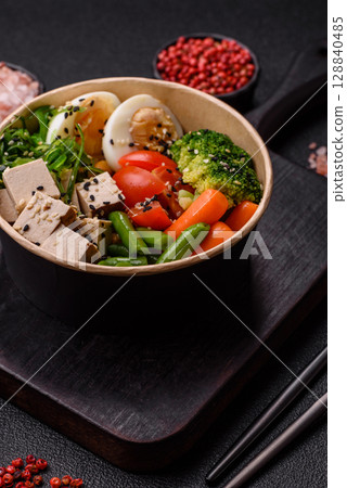 Vegan salad, bowls with chickpeas, broccoli, tomatoes, tofu cheese and boiled eggs Vegan salad, bowls with chickpeas, broccoli, tomatoes, tofu cheese and boiled eggs 128840485