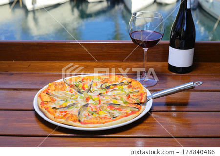 assorted pizza with different fillings: salami, tomatoes, mushrooms, bacon, sun-dried tomatoes. assorted pizza with different fillings: salami, tomatoes, mushrooms, bacon, sun-dried tomatoes. 128840486