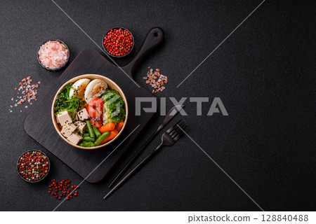 Vegan salad, bowls with chickpeas, broccoli, tomatoes, tofu cheese and boiled eggs Vegan salad, bowls with chickpeas, broccoli, tomatoes, tofu cheese and boiled eggs 128840488