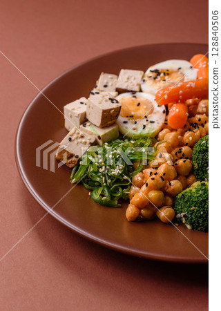 Vegan salad, bowls with chickpeas, broccoli, tomatoes, tofu cheese and boiled eggs 128840506
