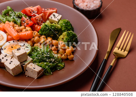 Vegan salad, bowls with chickpeas, broccoli, tomatoes, tofu cheese and boiled eggs Vegan salad, bowls with chickpeas, broccoli, tomatoes, tofu cheese and boiled eggs 128840508