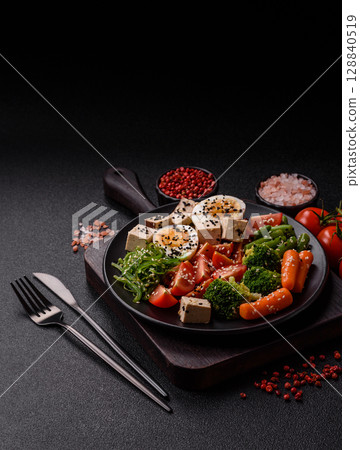 Vegan salad, bowls with chickpeas, broccoli, tomatoes, tofu cheese and boiled eggs Vegan salad, bowls with chickpeas, broccoli, tomatoes, tofu cheese and boiled eggs 128840519