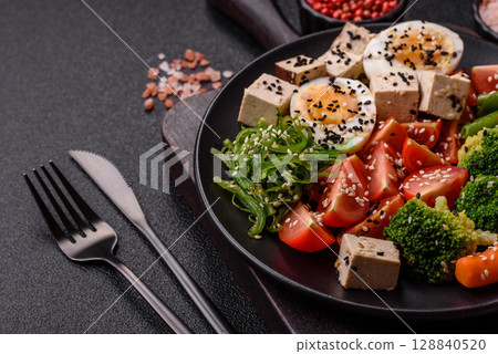 Vegan salad, bowls with chickpeas, broccoli, tomatoes, tofu cheese and boiled eggs 128840520