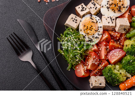 Vegan salad, bowls with chickpeas, broccoli, tomatoes, tofu cheese and boiled eggs Vegan salad, bowls with chickpeas, broccoli, tomatoes, tofu cheese and boiled eggs 128840521