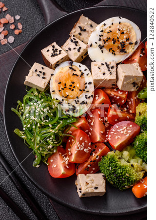 Vegan salad, bowls with chickpeas, broccoli, tomatoes, tofu cheese and boiled eggs Vegan salad, bowls with chickpeas, broccoli, tomatoes, tofu cheese and boiled eggs 128840522