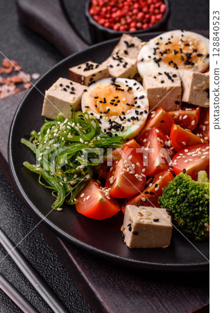 Vegan salad, bowls with chickpeas, broccoli, tomatoes, tofu cheese and boiled eggs Vegan salad, bowls with chickpeas, broccoli, tomatoes, tofu cheese and boiled eggs 128840523