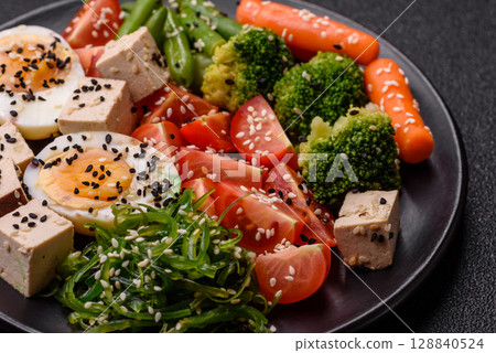 Vegan salad, bowls with chickpeas, broccoli, tomatoes, tofu cheese and boiled eggs 128840524