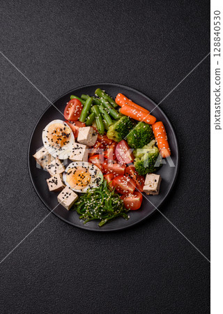 Vegan salad, bowls with chickpeas, broccoli, tomatoes, tofu cheese and boiled eggs Vegan salad, bowls with chickpeas, broccoli, tomatoes, tofu cheese and boiled eggs 128840530