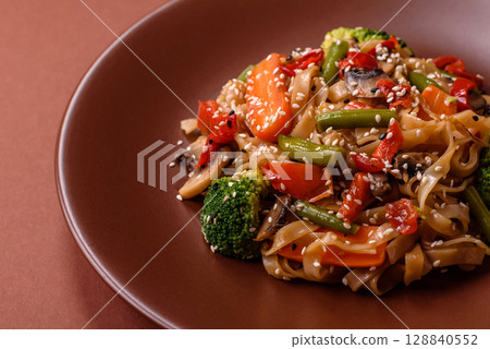 Chinese or Thai food, rice noodles with meat, salt and spices. Asian food Chinese or Thai food, rice noodles with meat, salt and spices. Asian food 128840552