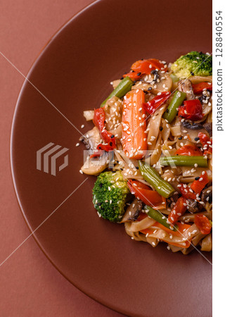Chinese or Thai food, rice noodles with meat, salt and spices. Asian food Chinese or Thai food, rice noodles with meat, salt and spices. Asian food 128840554