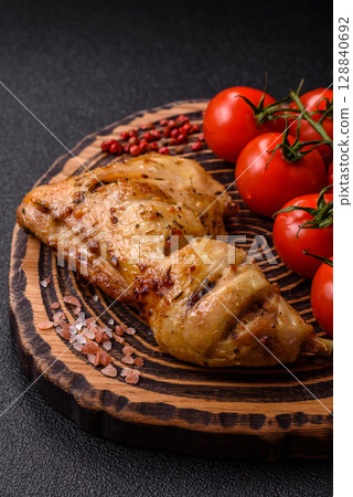 Grilled chicken leg or quarter. Barbecued meat with salt and spices Grilled chicken leg or quarter. Barbecued meat with salt and spices 128840692