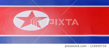 Flag of North Korea, red star on red blue white background 128840734