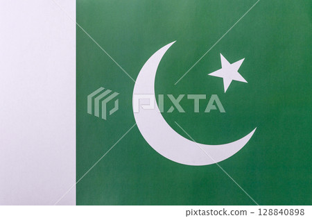 Pakistani flag, white crescent and white star on a green background Pakistani flag, white crescent and white star on a green background 128840898