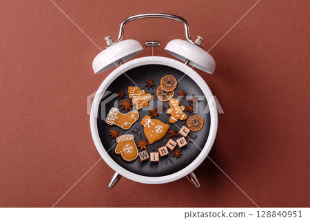 Christmas, gingerbread or biscuits on a plate on a clock. Christmas time conceptual background Christmas, gingerbread or biscuits on a plate on a clock. Christmas time conceptual background 128840951