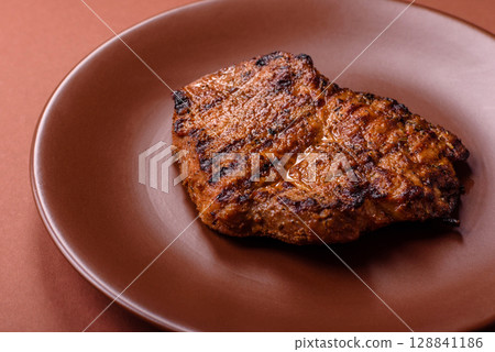 Meat, steak, beef tenderloin cooked on grill. Juicy steak as a food background 128841186