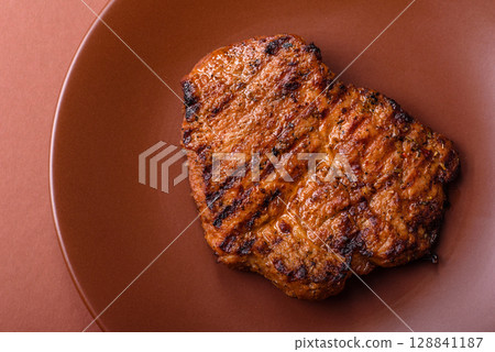 Meat, steak, beef tenderloin cooked on grill. Juicy steak as a food background 128841187