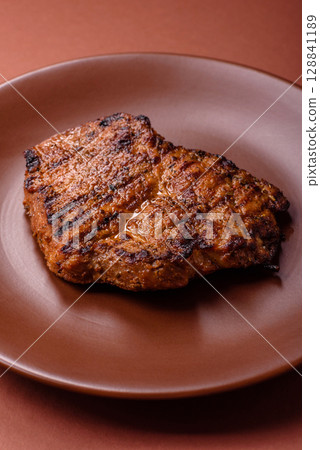 Meat, steak, beef tenderloin cooked on grill. Juicy steak as a food background 128841189