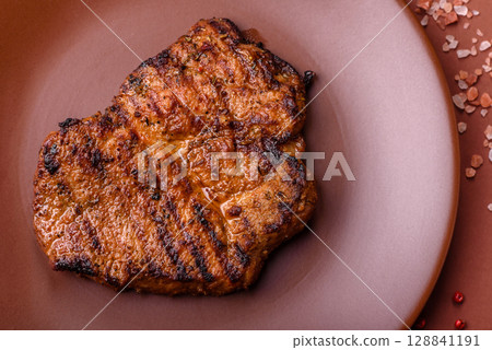 Meat, steak, beef tenderloin cooked on grill. Juicy steak as a food background 128841191