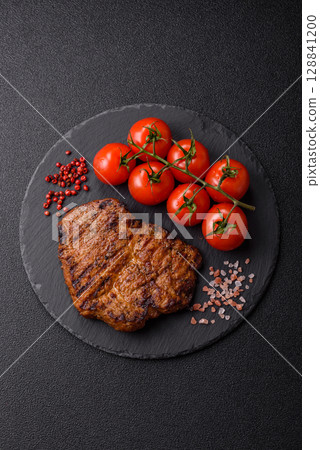 Meat, steak, beef tenderloin cooked on grill. Juicy steak as a food background Meat, steak, beef tenderloin cooked on grill. Juicy steak as a food background 128841200