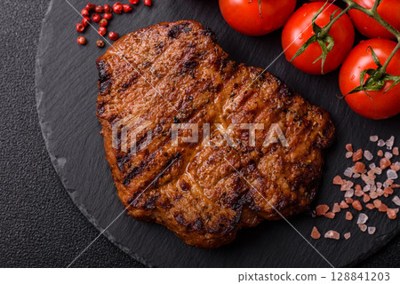 Meat, steak, beef tenderloin cooked on grill. Juicy steak as a food background Meat, steak, beef tenderloin cooked on grill. Juicy steak as a food background 128841203
