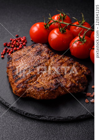 Meat, steak, beef tenderloin cooked on grill. Juicy steak as a food background 128841205