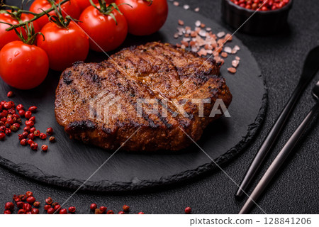 Meat, steak, beef tenderloin cooked on grill. Juicy steak as a food background 128841206