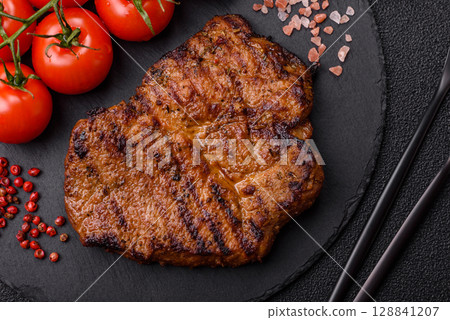 Meat, steak, beef tenderloin cooked on grill. Juicy steak as a food background Meat, steak, beef tenderloin cooked on grill. Juicy steak as a food background 128841207