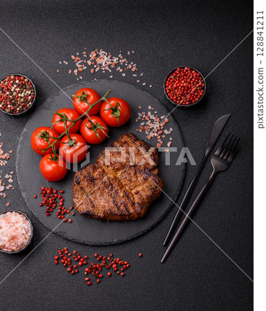 Meat, steak, beef tenderloin cooked on grill. Juicy steak as a food background 128841211