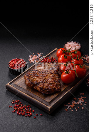Meat, steak, beef tenderloin cooked on grill. Juicy steak as a food background Meat, steak, beef tenderloin cooked on grill. Juicy steak as a food background 128841216