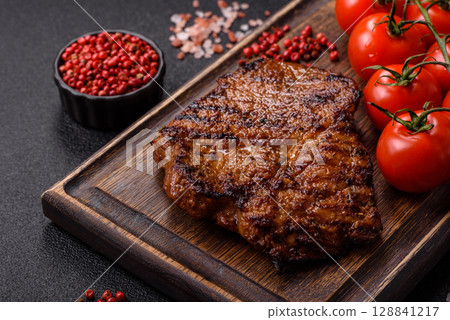 Meat, steak, beef tenderloin cooked on grill. Juicy steak as a food background 128841217