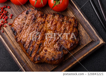 Meat, steak, beef tenderloin cooked on grill. Juicy steak as a food background 128841221
