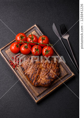 Meat, steak, beef tenderloin cooked on grill. Juicy steak as a food background 128841226