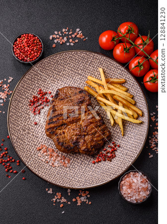 Meat, steak, beef tenderloin cooked on grill. Juicy steak as a food background 128841230
