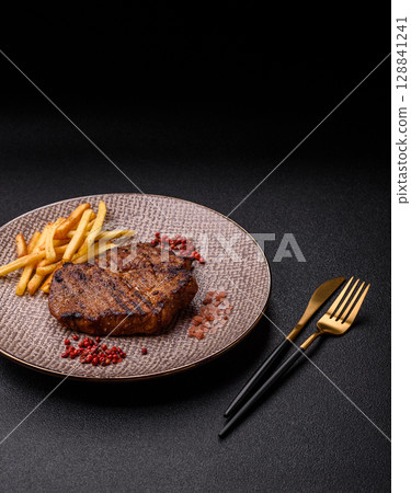 Meat, steak, beef tenderloin cooked on grill. Juicy steak as a food background Meat, steak, beef tenderloin cooked on grill. Juicy steak as a food background 128841241