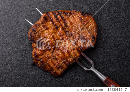 Meat, steak, beef tenderloin cooked on grill. Juicy steak as a food background Meat, steak, beef tenderloin cooked on grill. Juicy steak as a food background 128841247