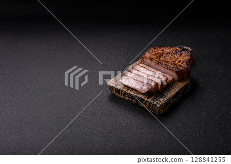 Meat, steak, beef tenderloin cooked on grill. Juicy steak as a food background 128841255