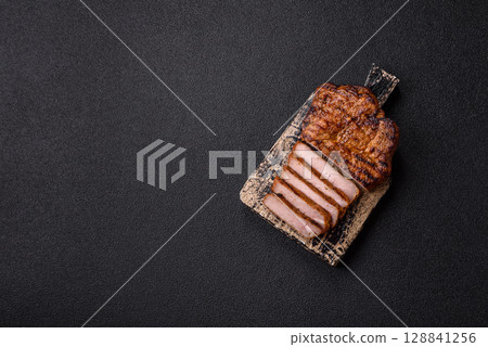 Meat, steak, beef tenderloin cooked on grill. Juicy steak as a food background Meat, steak, beef tenderloin cooked on grill. Juicy steak as a food background 128841256