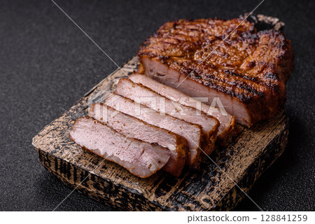 Meat, steak, beef tenderloin cooked on grill. Juicy steak as a food background Meat, steak, beef tenderloin cooked on grill. Juicy steak as a food background 128841259