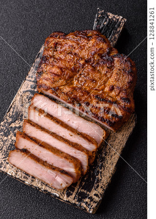 Meat, steak, beef tenderloin cooked on grill. Juicy steak as a food background Meat, steak, beef tenderloin cooked on grill. Juicy steak as a food background 128841261