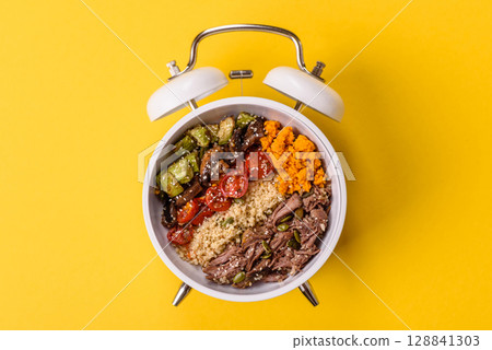 Vegetarian salad with quinoa, vegetables and meat. Conceptual background time to eat vegetarian food 128841303