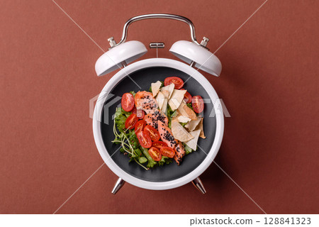 Salad with chicken, tomatoes and eggs with seeds and grains. Concept time to eat dinner Salad with chicken, tomatoes and eggs with seeds and grains. Concept time to eat dinner 128841323