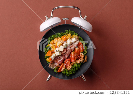 Salad with chicken, tomatoes and eggs with seeds and grains. Concept time to eat dinner 128841331