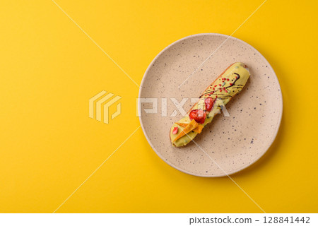 French food, dessert eclair with chocolate filling. Eclair as a background 128841442