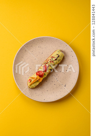 French food, dessert eclair with chocolate filling. Eclair as a background French food, dessert eclair with chocolate filling. Eclair as a background 128841443